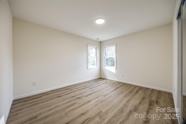 unfurnished room with light wood-type flooring