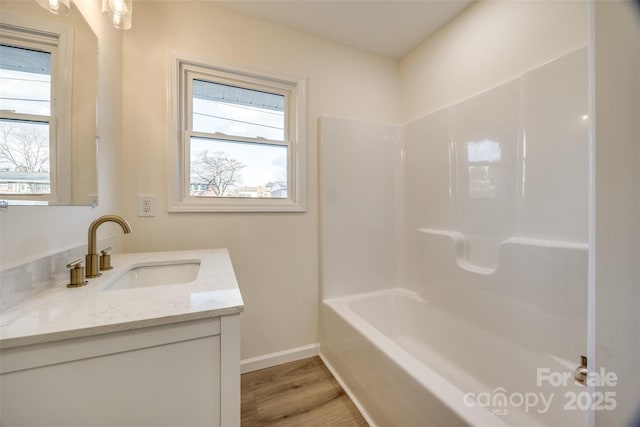 bathroom with shower / tub combination, vanity, and wood-type flooring