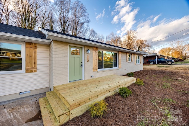 doorway to property with a wooden deck