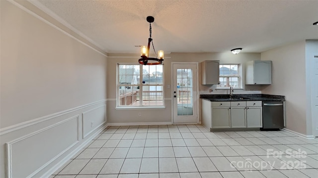 kitchen with dishwasher, gray cabinets, light tile patterned floors, and a chandelier