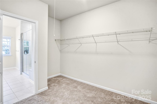 spacious closet with light tile patterned floors