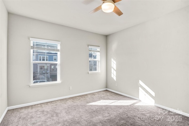 spare room with light colored carpet and ceiling fan