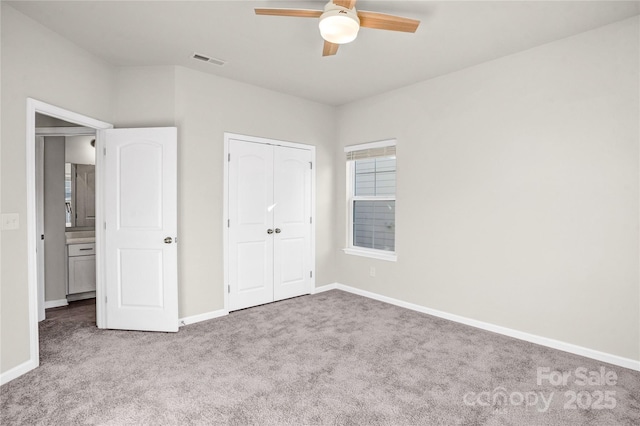 unfurnished bedroom with ceiling fan, a closet, and light colored carpet