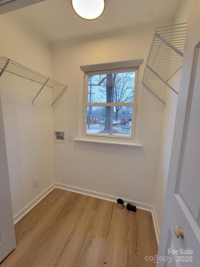 washroom featuring hookup for a washing machine and hardwood / wood-style flooring