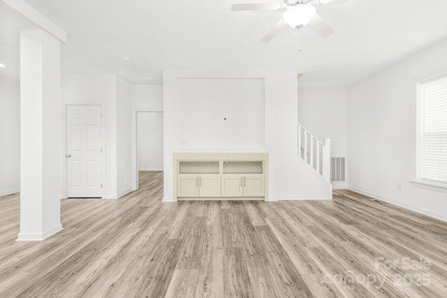 unfurnished living room featuring light hardwood / wood-style flooring and ceiling fan