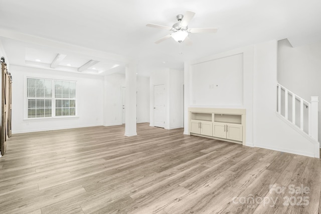 unfurnished living room with ceiling fan, beamed ceiling, and light wood-type flooring