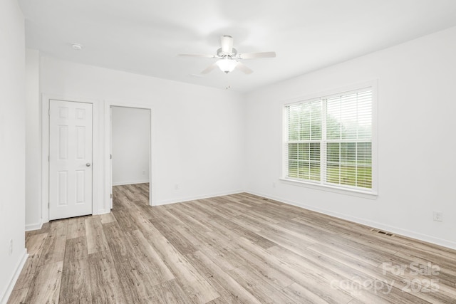 empty room featuring ceiling fan and light hardwood / wood-style flooring