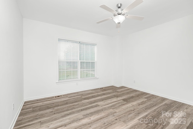 unfurnished room with ceiling fan and light hardwood / wood-style floors