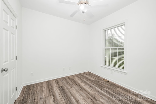 spare room with hardwood / wood-style floors and ceiling fan