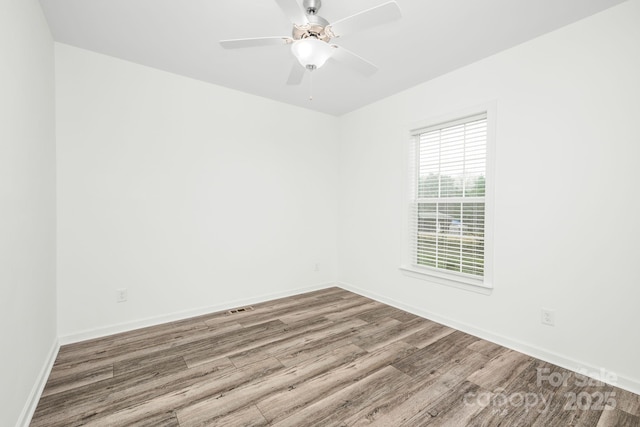 empty room featuring ceiling fan and hardwood / wood-style floors