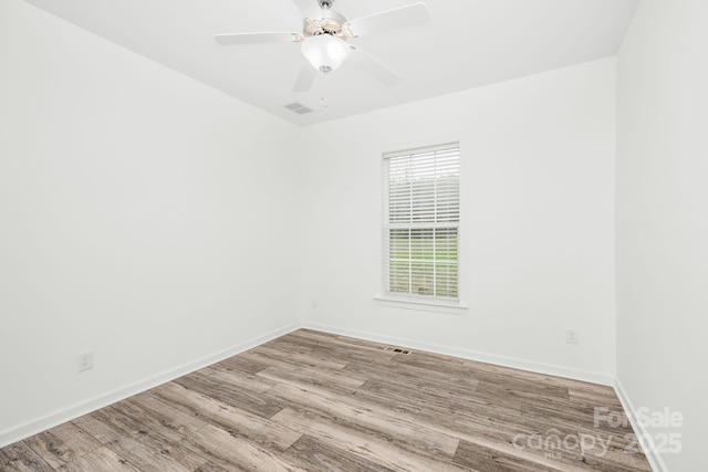 empty room featuring ceiling fan and light hardwood / wood-style flooring