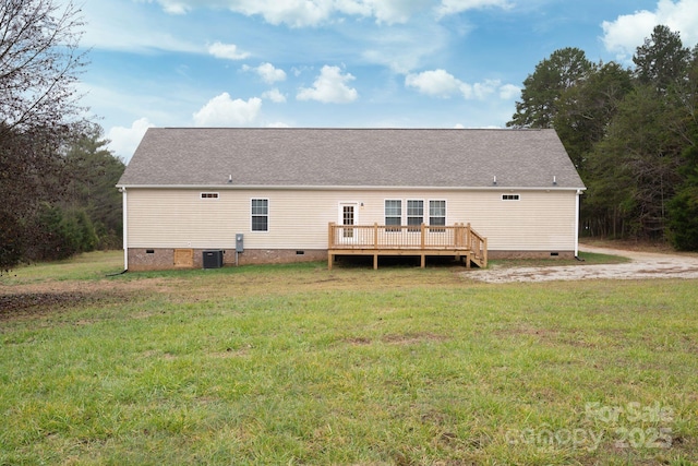 back of property featuring a deck, central AC unit, and a lawn