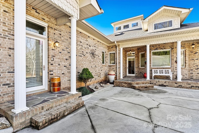 view of exterior entry featuring covered porch