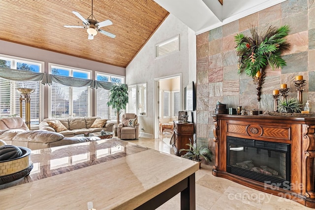 living room featuring wood ceiling, ceiling fan, high vaulted ceiling, tile walls, and a tiled fireplace