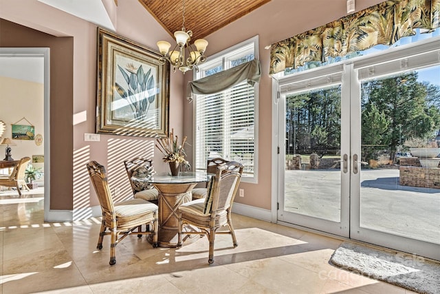 dining space with lofted ceiling, french doors, light tile patterned floors, a notable chandelier, and wood ceiling