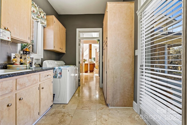 clothes washing area with cabinets, independent washer and dryer, and sink