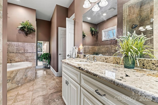 bathroom featuring vanity and separate shower and tub