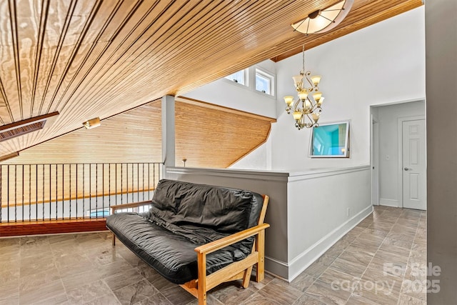 sitting room with a chandelier and wood ceiling