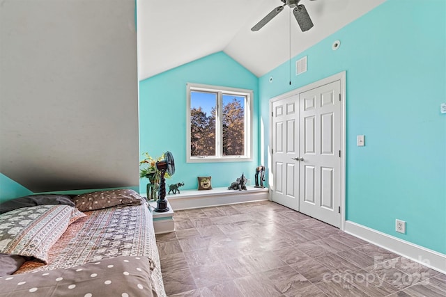 bedroom featuring ceiling fan, a closet, and lofted ceiling