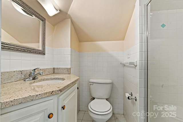 bathroom with walk in shower, tile patterned floors, toilet, vanity, and tile walls