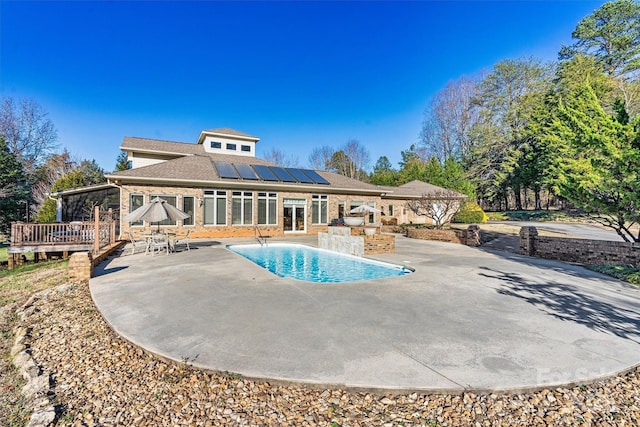 view of pool with a patio area and a wooden deck