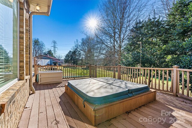 wooden deck with a covered hot tub