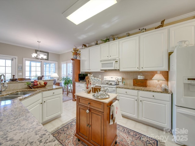 kitchen featuring white appliances, sink, decorative light fixtures, a notable chandelier, and white cabinetry