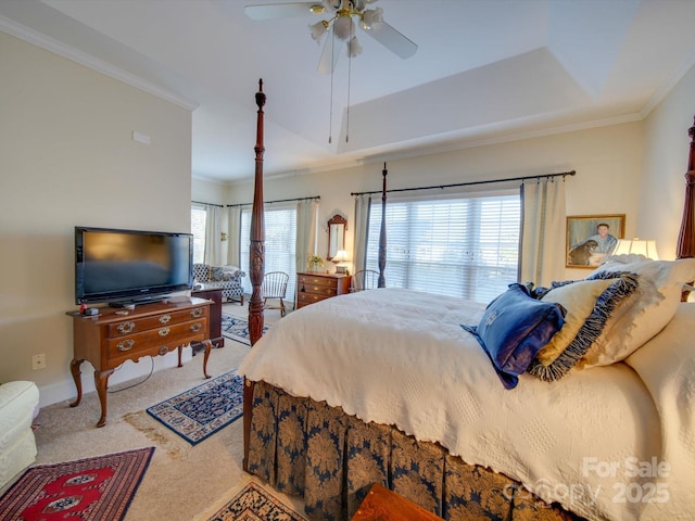 bedroom with a raised ceiling, ceiling fan, carpet, and ornamental molding