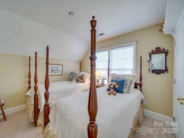 carpeted bedroom with lofted ceiling