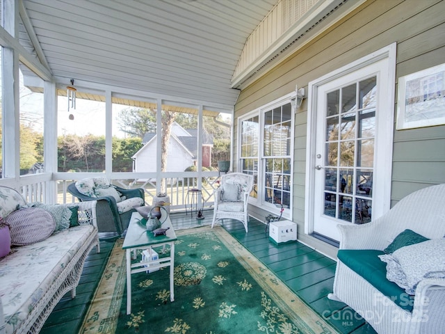 sunroom / solarium featuring plenty of natural light and lofted ceiling