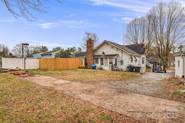 back of property featuring a yard