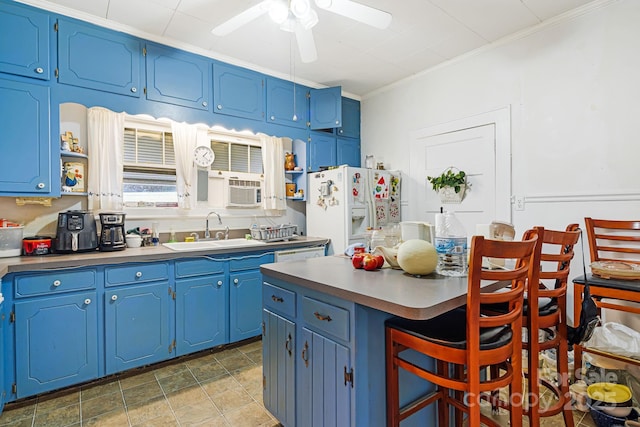 kitchen featuring sink, ornamental molding, white refrigerator with ice dispenser, and blue cabinets