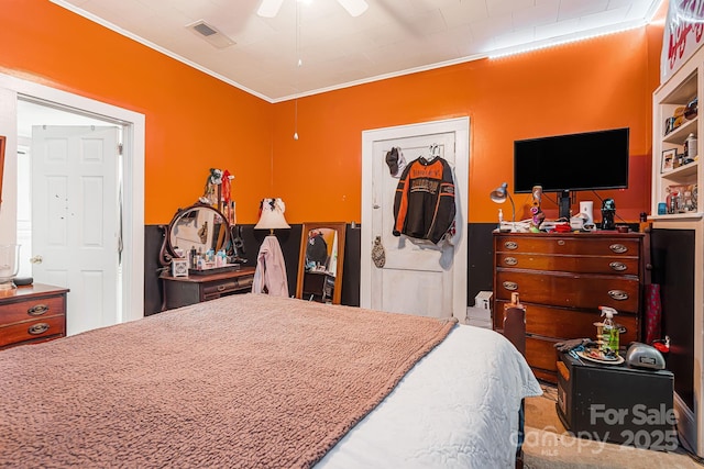 bedroom with ceiling fan and crown molding