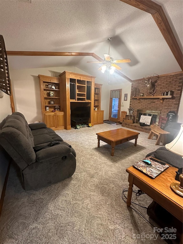 living room featuring carpet floors, ceiling fan, a fireplace, a textured ceiling, and lofted ceiling