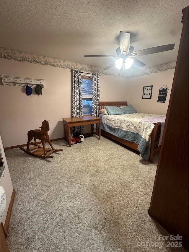 carpeted bedroom with a textured ceiling and ceiling fan