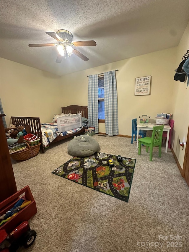 carpeted bedroom featuring ceiling fan and a textured ceiling