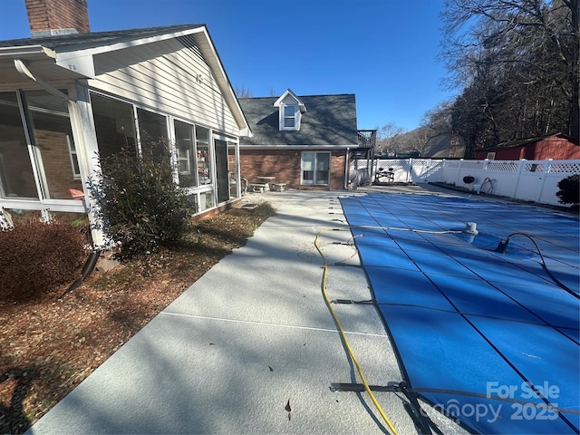 exterior space featuring a sunroom and a patio area