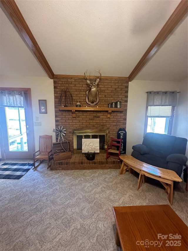 unfurnished living room with a brick fireplace, carpet, and beamed ceiling