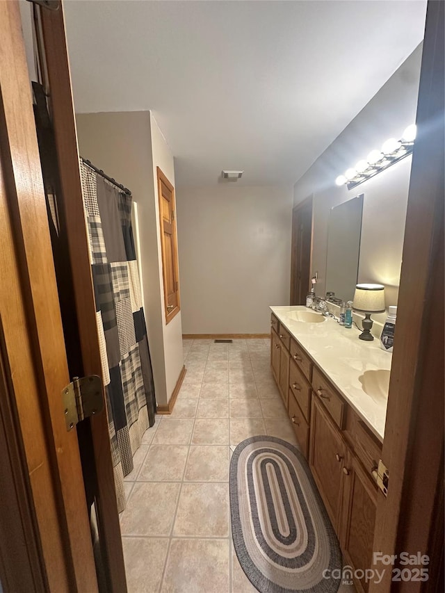 bathroom with tile patterned flooring and vanity