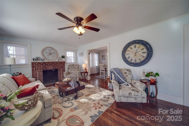 living room featuring a fireplace, ceiling fan, and dark wood-type flooring