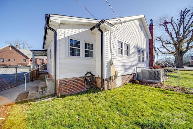 rear view of property featuring a lawn, a patio area, and cooling unit