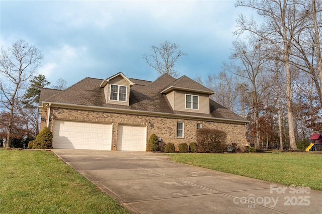 view of front of property with a garage and a front yard