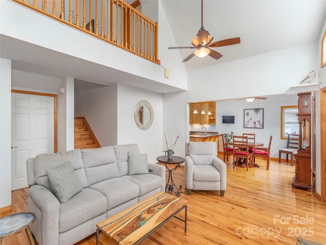1185 Mule Stomp Rd, Clyde, NC 28721 - living room featuring high vaulted ceiling, a ceiling fan, light wood-style floors, and stairway
