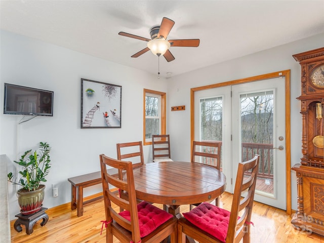 dining area with light hardwood / wood-style floors and ceiling fan