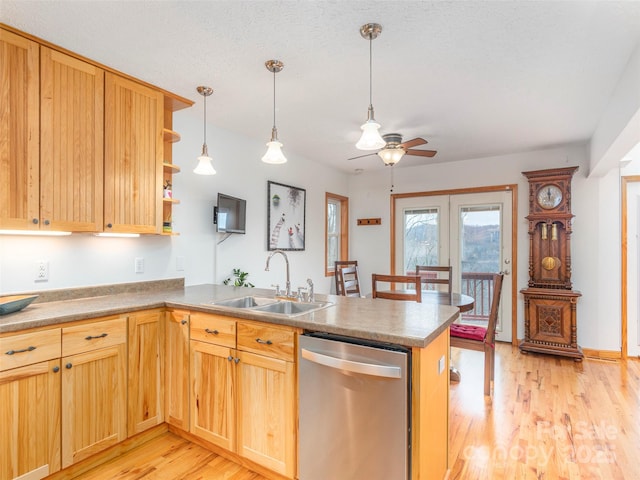 kitchen with ceiling fan, dishwasher, sink, kitchen peninsula, and light wood-type flooring