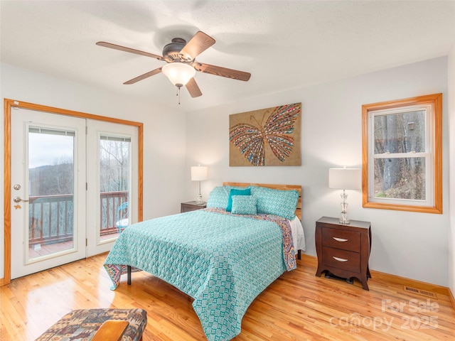 bedroom featuring ceiling fan, light hardwood / wood-style floors, and access to exterior