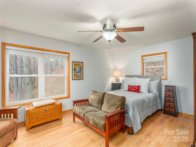 1185 Mule Stomp Rd, Clyde, NC 28721 - bedroom with wood finished floors and a ceiling fan