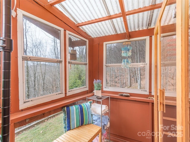 unfurnished sunroom with vaulted ceiling