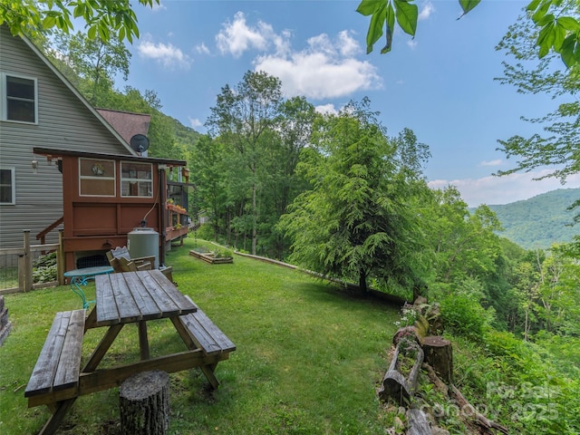 1185 Mule Stomp Rd, Clyde, NC 28721 - view of grassy yard featuring a mountain view, a wooded view, and outdoor dining space
