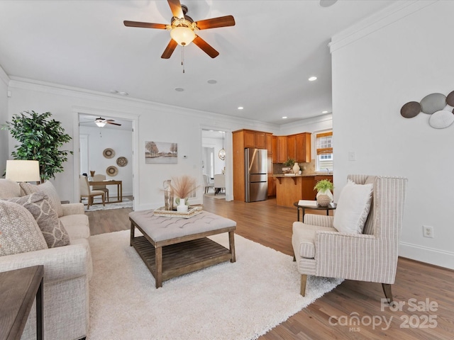 living room featuring light hardwood / wood-style floors and ornamental molding